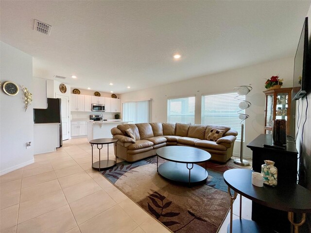 1393 Asher Mason Ave, Kissimmee, FL 34744 - living area featuring light tile patterned flooring, recessed lighting, and baseboards