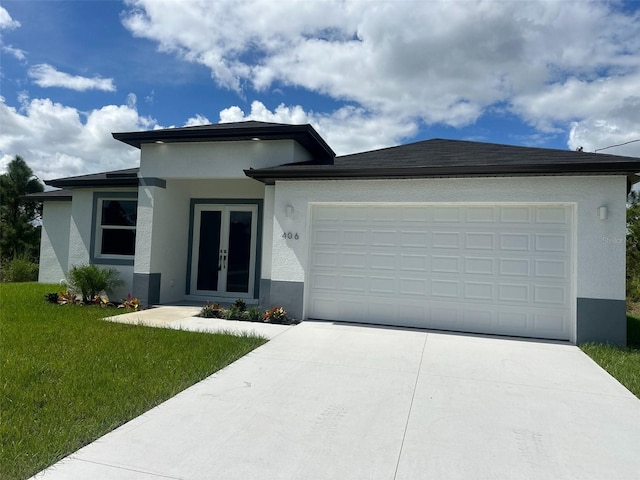 prairie-style home with a garage and a front lawn