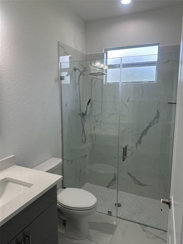 bathroom with vanity, walk in shower, and toilet