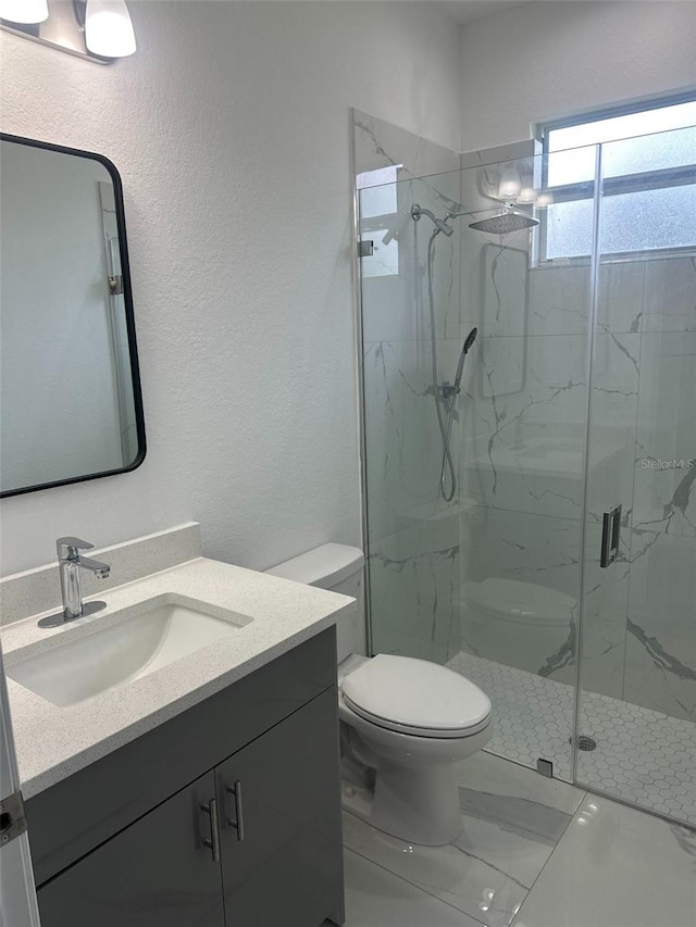 bathroom with walk in shower, vanity, and toilet