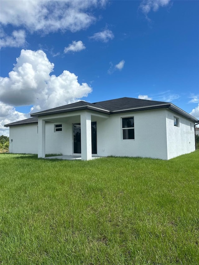 rear view of house with a lawn