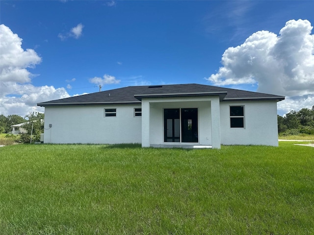 rear view of property with a yard