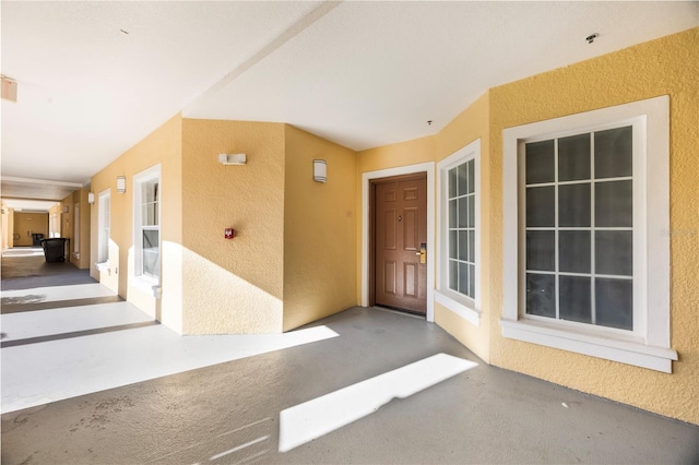 entrance to property with stucco siding