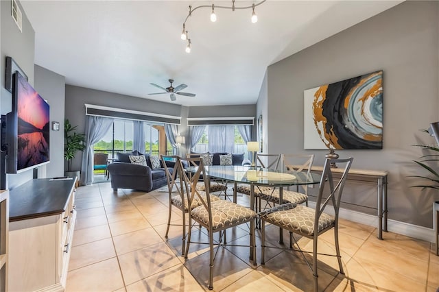 dining space with plenty of natural light, a ceiling fan, visible vents, and light tile patterned floors