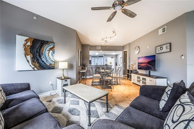 living area with a ceiling fan, baseboards, light tile patterned flooring, and visible vents
