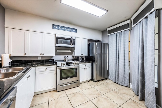 kitchen with white cabinets, appliances with stainless steel finishes, and a sink
