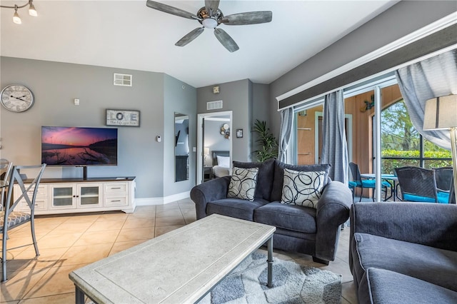living area featuring baseboards, a ceiling fan, visible vents, and light tile patterned flooring