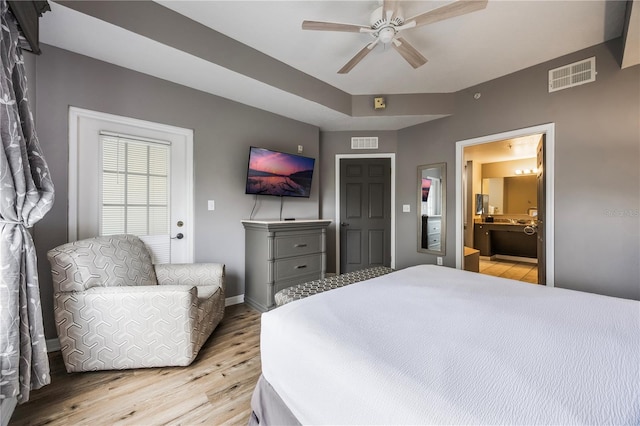 bedroom featuring ensuite bath, light wood-type flooring, and ceiling fan