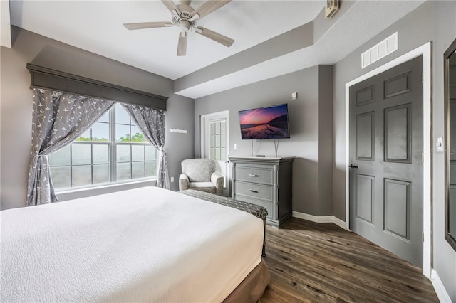 bedroom with baseboards, visible vents, ceiling fan, and dark wood-style flooring