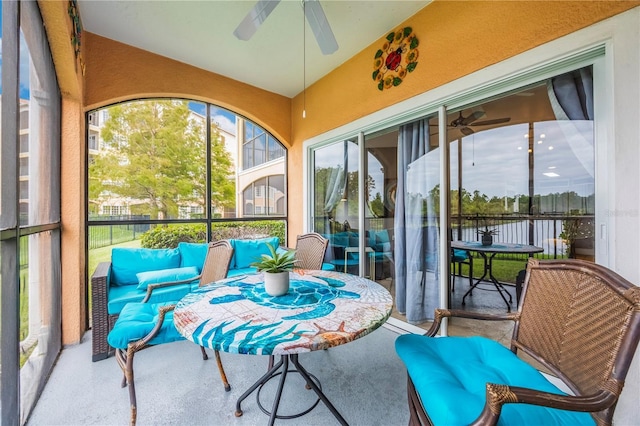 sunroom / solarium featuring a ceiling fan