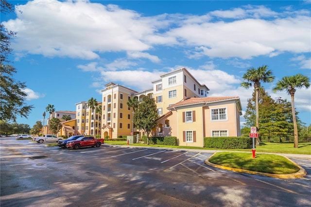 view of property featuring uncovered parking