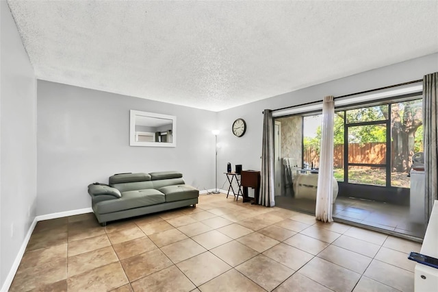 living room with light tile patterned floors and a textured ceiling