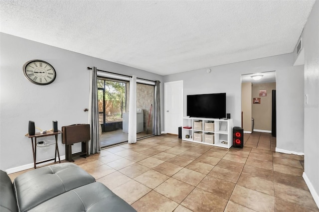 living room featuring a textured ceiling and light tile patterned flooring