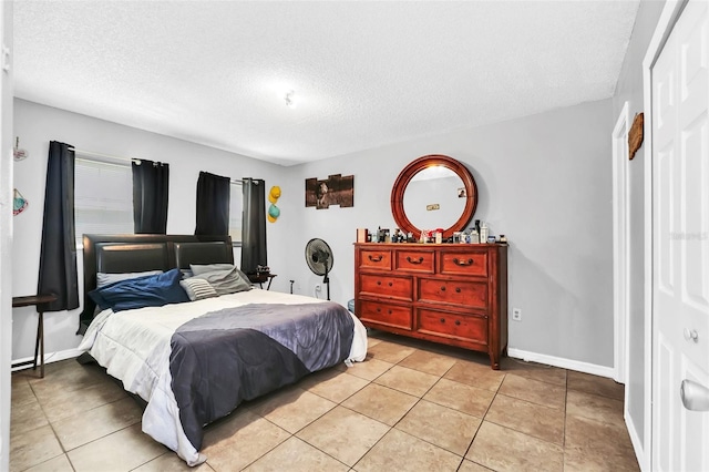 tiled bedroom with a textured ceiling