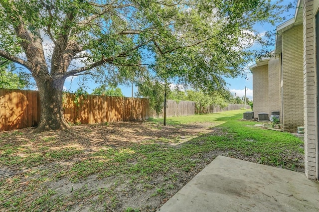 view of yard with central air condition unit and a patio area