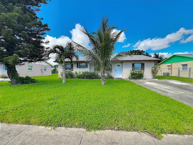 ranch-style home with a front lawn