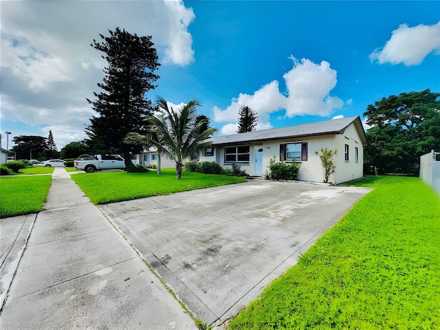 ranch-style home with a front lawn