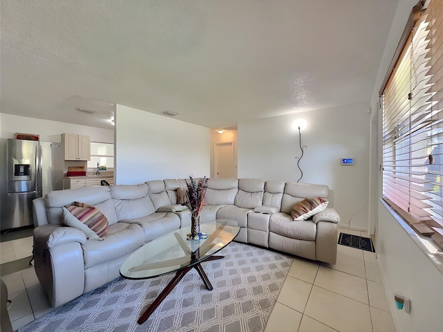 living room featuring light tile patterned floors and a textured ceiling