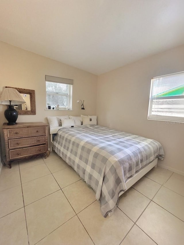 bedroom featuring light tile patterned flooring and multiple windows