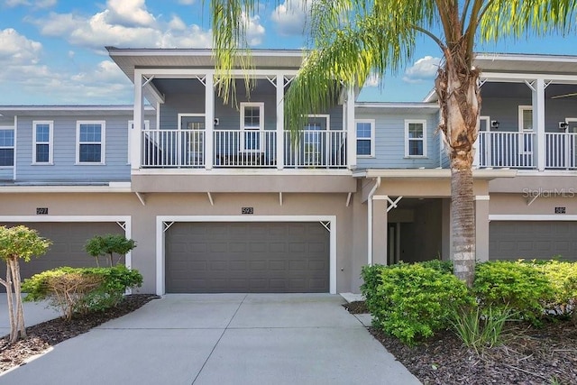 view of property with a garage and a balcony