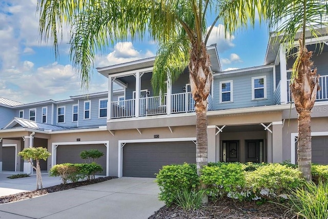 view of property featuring a balcony and a garage