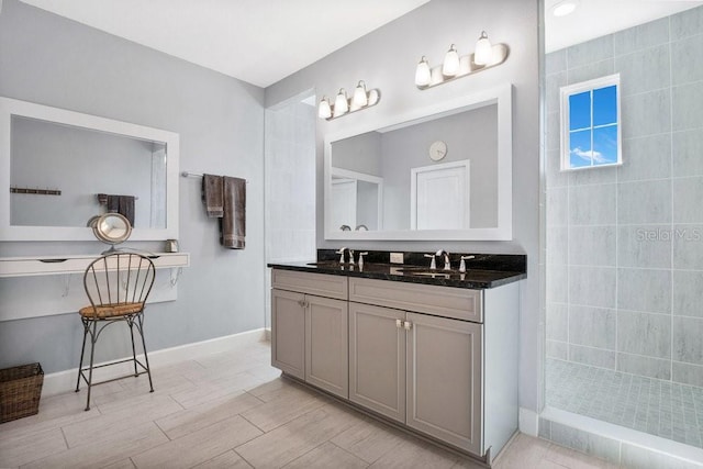 593 Lake Wildmere Cv, Longwood, FL 32750 - bathroom featuring a walk in shower, double vanity, wood finished floors, and baseboards