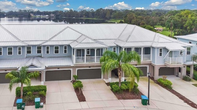 593 Lake Wildmere Cv, Longwood, FL 32750 - view of front of house with an attached garage, driveway, metal roof, and stucco siding