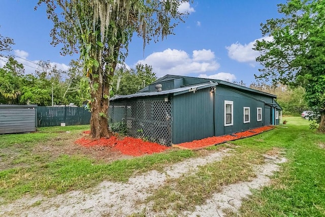 view of side of home with a lawn