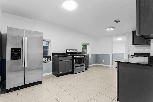 kitchen featuring light tile patterned flooring and appliances with stainless steel finishes