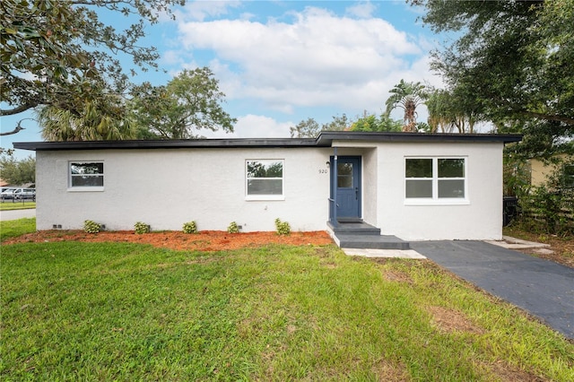 ranch-style house with a front lawn