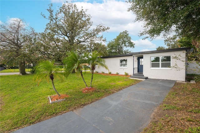 ranch-style home with a front yard