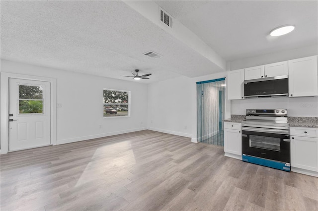 kitchen featuring white cabinets, stainless steel appliances, and plenty of natural light