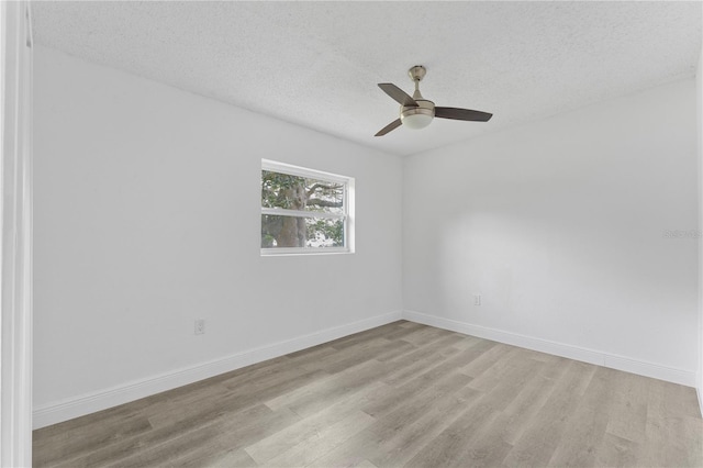 spare room featuring light hardwood / wood-style flooring, a textured ceiling, and ceiling fan