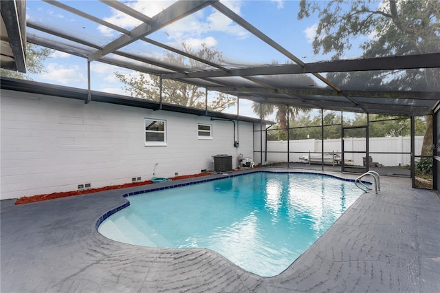 view of pool with central AC, a patio, and a lanai