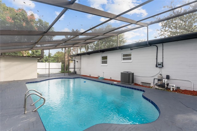 view of swimming pool with a patio area, central AC unit, and a lanai