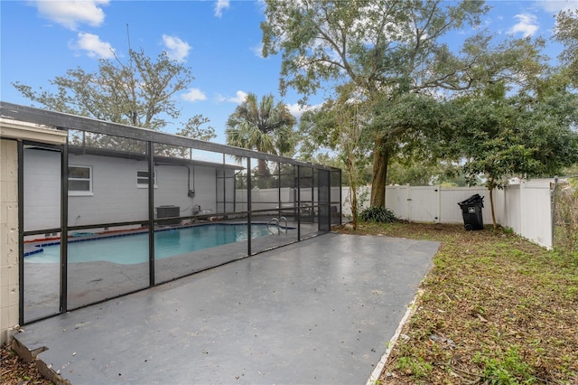 view of swimming pool with a patio and a lanai