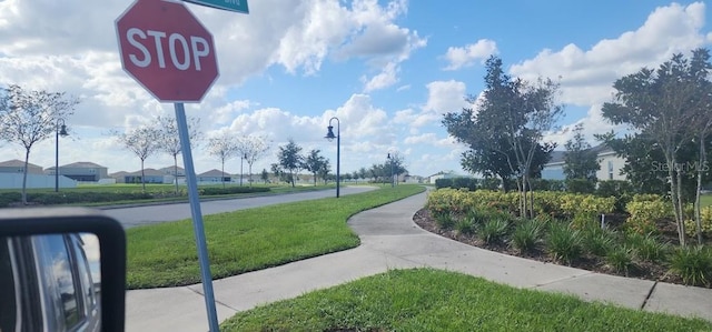 view of property's community with a lawn