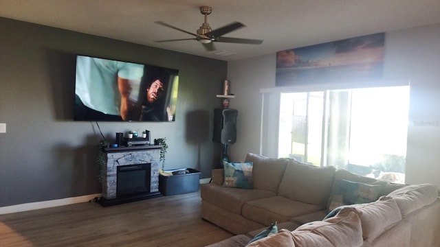 living room featuring hardwood / wood-style floors, a fireplace, and ceiling fan