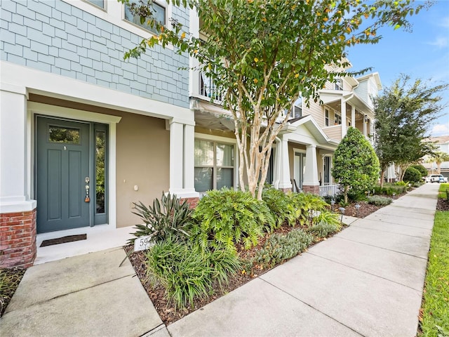 594 Piazza Pt, Oviedo, FL 32765 - doorway to property with stucco siding and covered porch