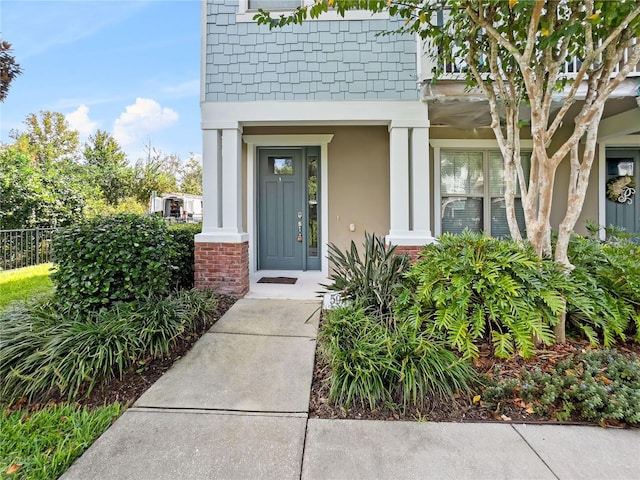 594 Piazza Pt, Oviedo, FL 32765 - property entrance with stucco siding, a porch, and fence