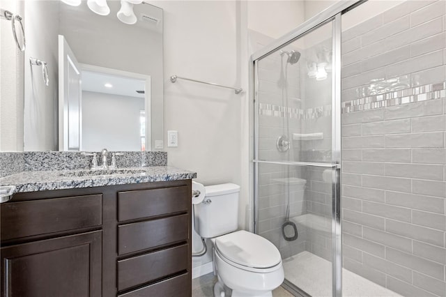 bathroom with vanity, walk in shower, and toilet