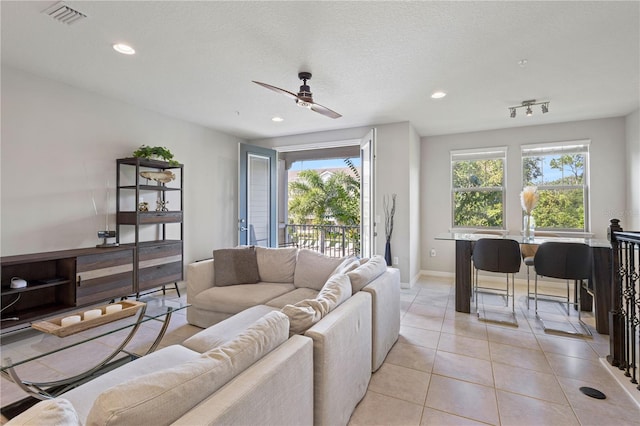 594 Piazza Pt, Oviedo, FL 32765 - living room with ceiling fan, light tile patterned flooring, baseboards, and recessed lighting