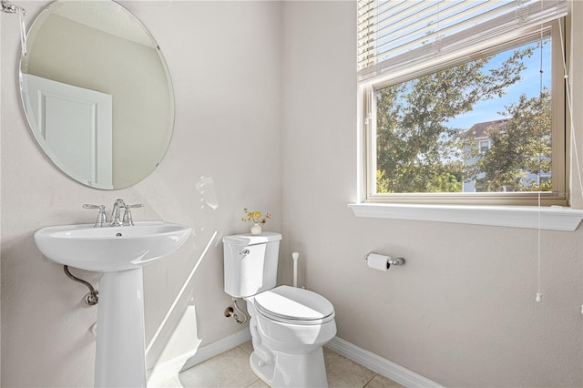 bathroom featuring tile patterned floors, plenty of natural light, and toilet