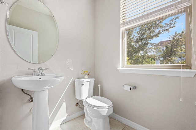 594 Piazza Pt, Oviedo, FL 32765 - bathroom featuring toilet, tile patterned floors, baseboards, and a sink