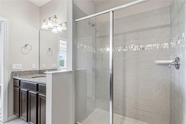 bathroom featuring an enclosed shower and vanity