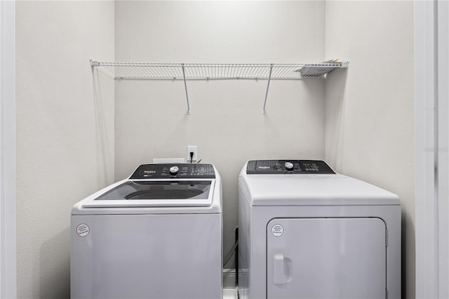 clothes washing area featuring washer and dryer