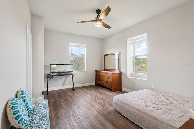 bedroom with ceiling fan and dark hardwood / wood-style flooring