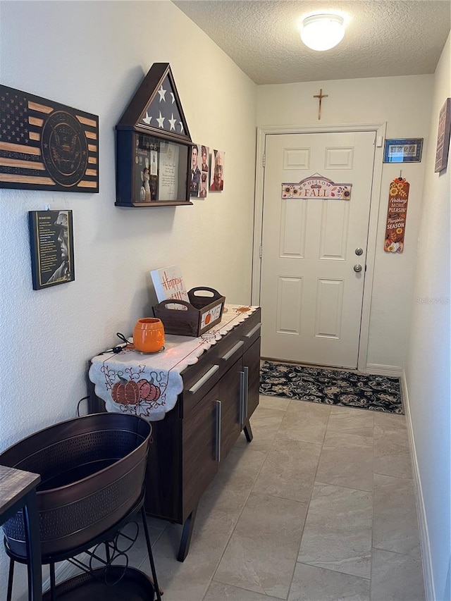 entryway featuring a textured ceiling