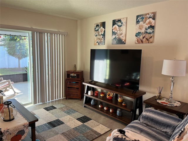 living room with a textured ceiling and light tile patterned flooring