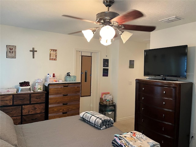 bedroom featuring a closet, ceiling fan, and a textured ceiling